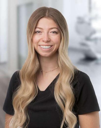 Jaelynn, dental team member, smiling in professional portrait at Salt Lake City practice.