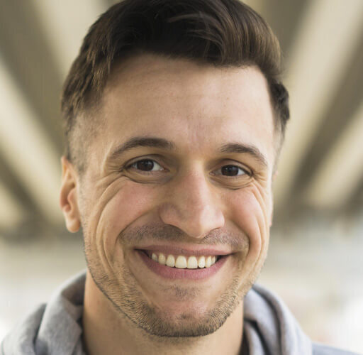 Smiling patient showing natural-looking results after porcelain veneers treatment