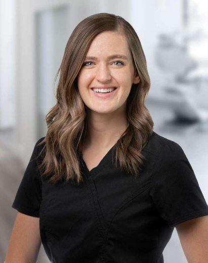 Areiann, dental team member, smiling in professional black scrubs at Salt Lake City practice.