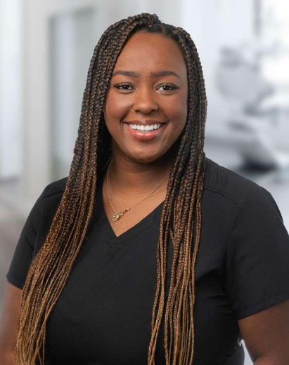 Jasmine, dental team member at Salt Lake City practice, smiling in professional portrait.