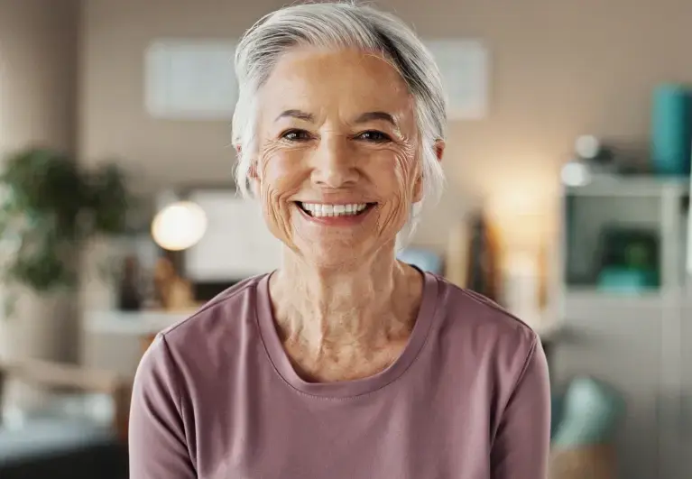 Happy patient smiling confidently with new dentures from Cottonwood Dental.