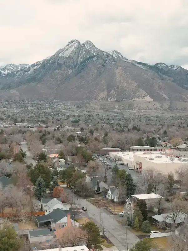 Snow-capped mountain overlooking Salt Lake City dental practice location with residential neighborhood below.