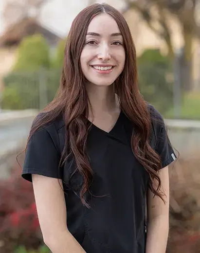 Alex, Lead Dental Assistant at Salt Lake City dental practice, smiling outdoors.