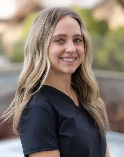 Bailee, dental team member at Salt Lake City practice, smiling outdoors.