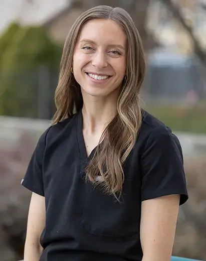 Dental hygienist smiling in a clinical setting