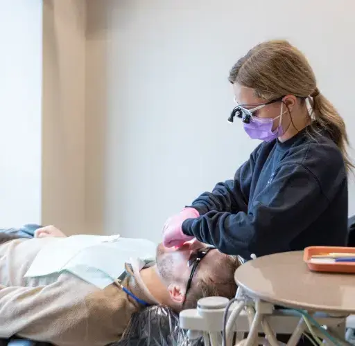 Dental patient receiving guidance on caring for porcelain veneers