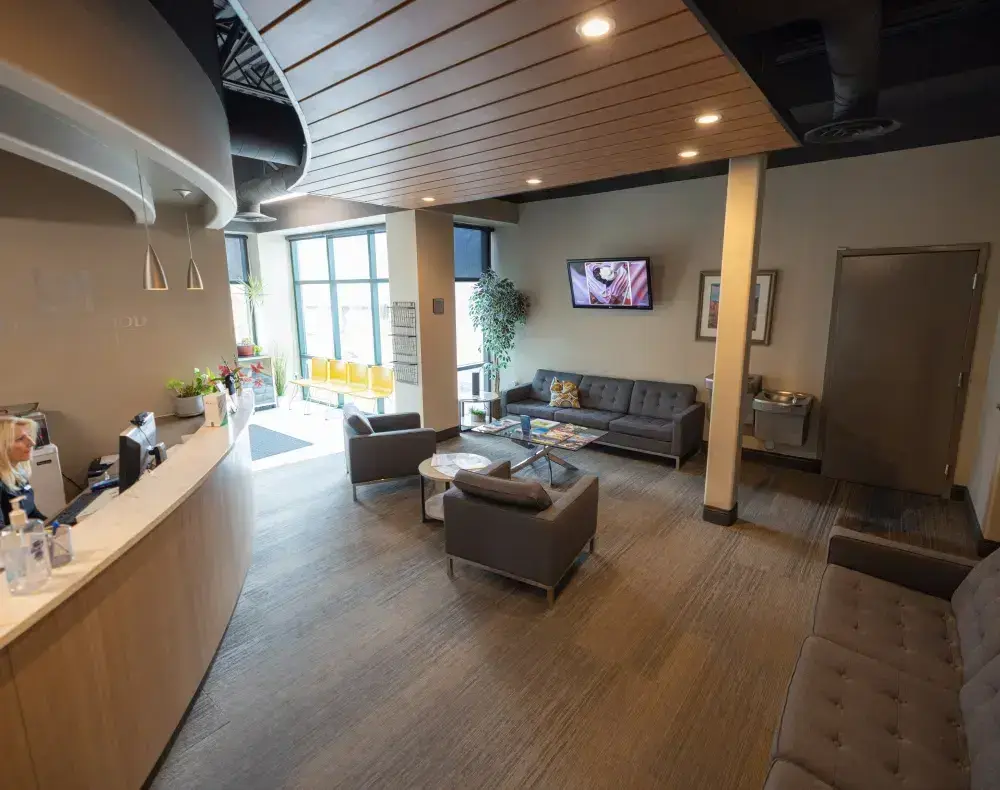 Cottonwood Dental office reception area with modern furniture, welcoming seating, and large windows in Salt Lake City.