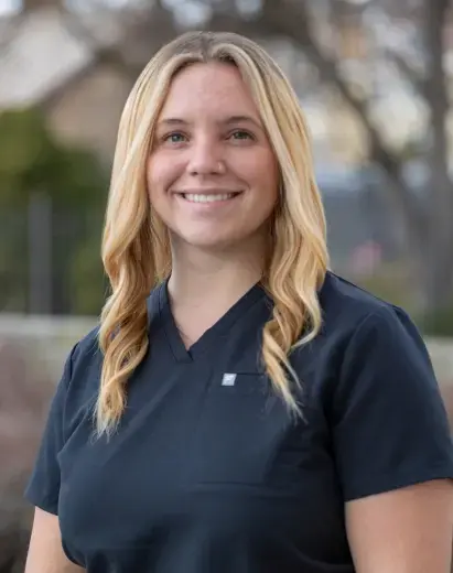 Olivia, dental team member at Highland Drive practice in Salt Lake City, smiling outdoors.
