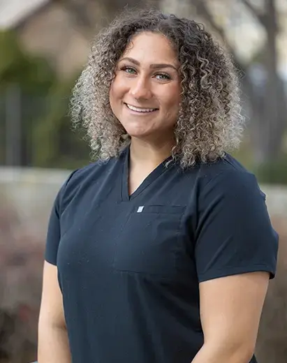 Peyton, a dental assistant, smiling in a clinical dental setting